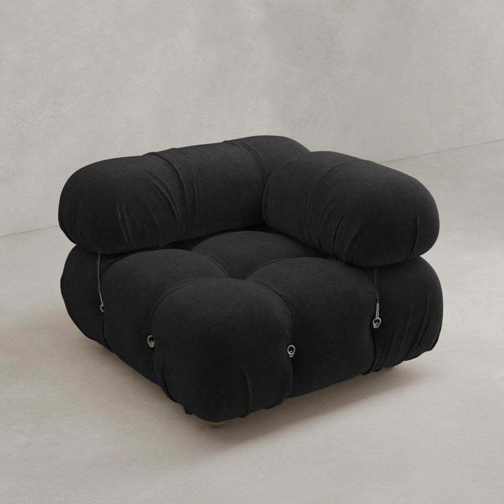 The Belmont Sofa Left Armrest is a black, modern modular seat with plush, rounded cushions and visible seams, shown against a plain light gray background.