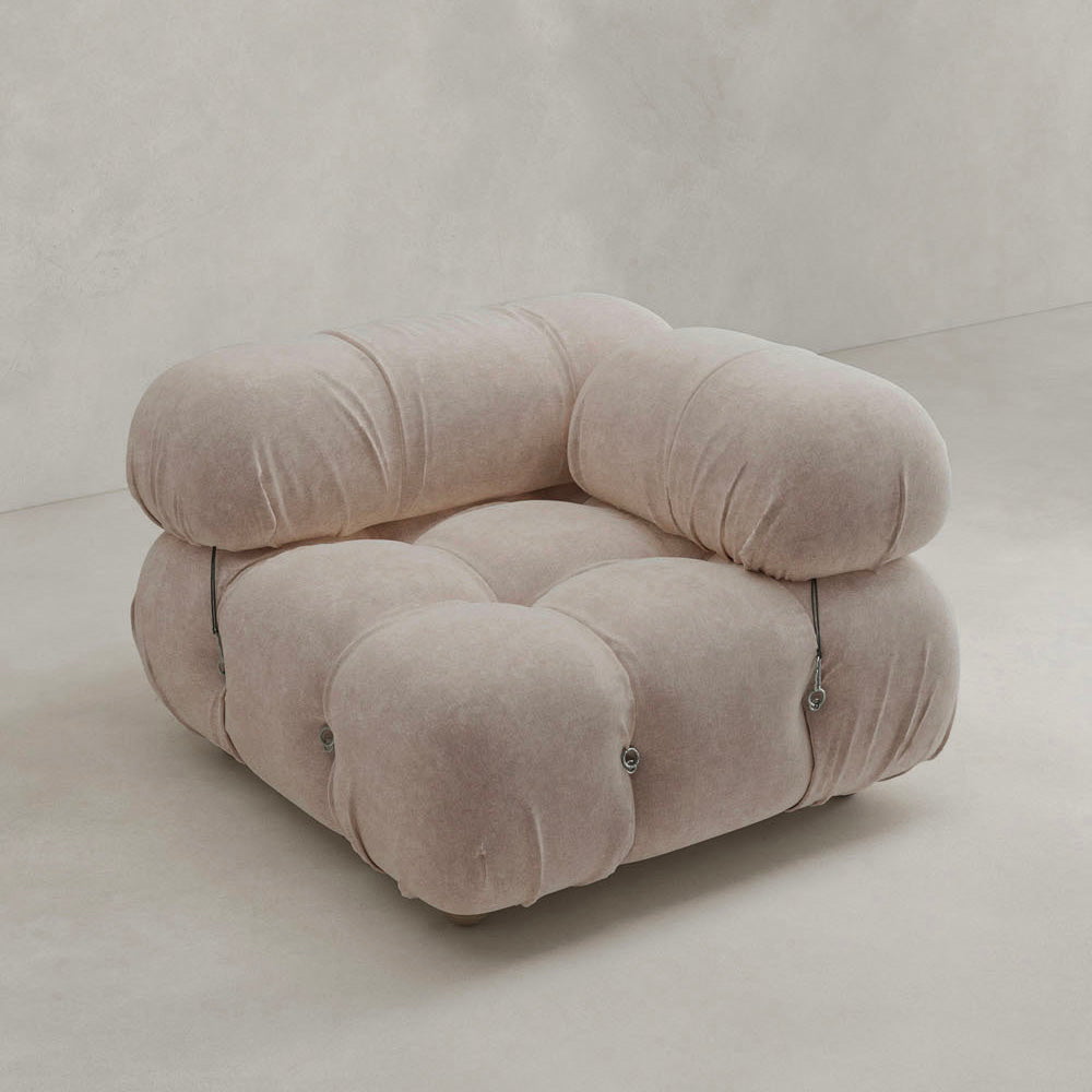 The Belmont Sofa Left Armrest is a plush, light beige seat with marshmallow-like curves, a tufted rounded design, and visible metal fasteners, set against a plain light background.