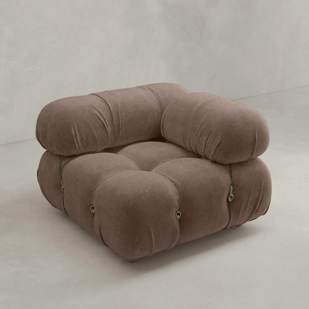 A plush, modern Belmont Sofa Left Armrest with marshmallow curves and rounded, tufted cushions in soft brown upholstery, featuring metal side fasteners, set against a plain, light background.