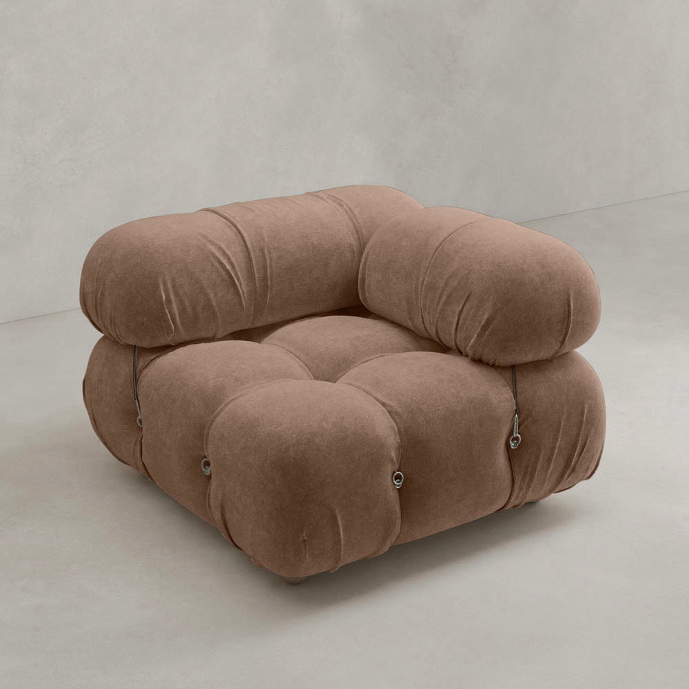 The Belmont Sofa Left Armrest features plush, marshmallow-like curves, rounded tufted cushions in soft brown fabric, a low wide seat, and metal button accents—an iconic classic set against a plain light background.