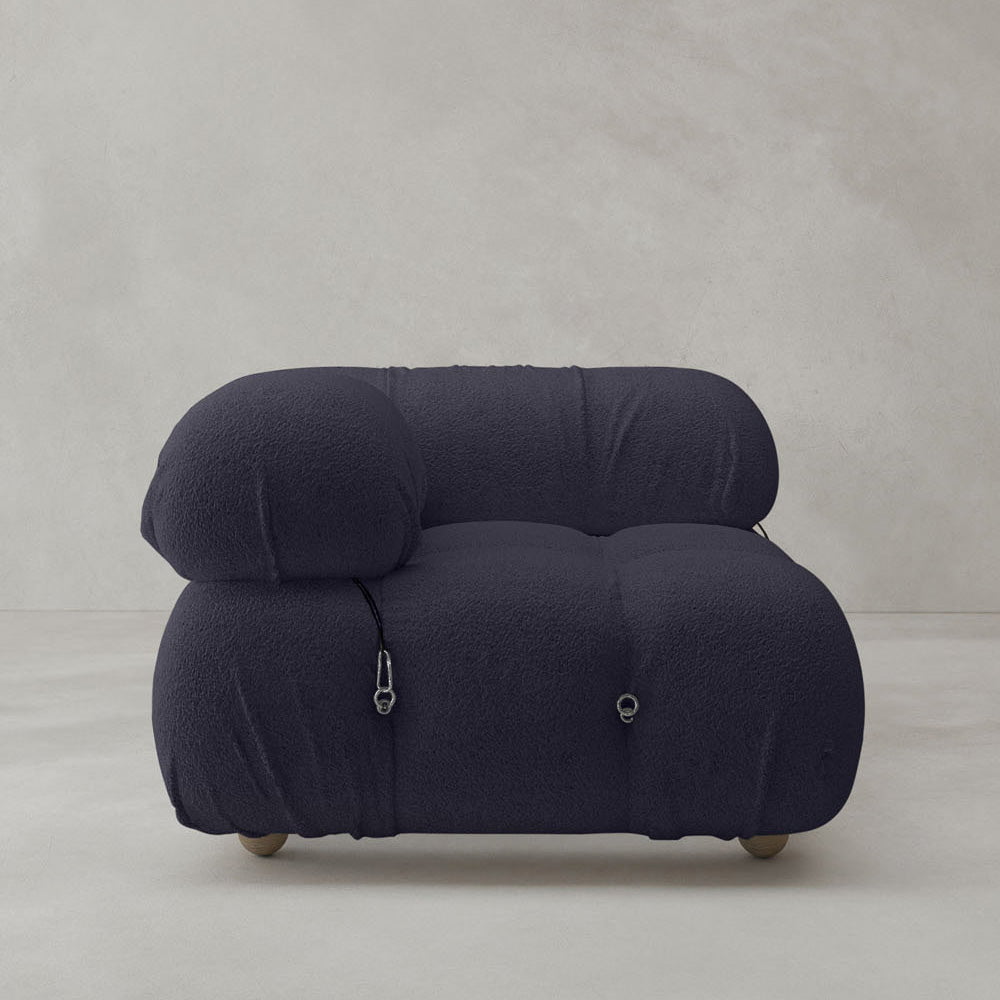 The Belmont Sofa Right Armrest features a modern, oversized design in dark gray with plush, textured fabric, rounded shapes, and visible buckle straps—perfect for minimalist spaces with light, neutral backgrounds.