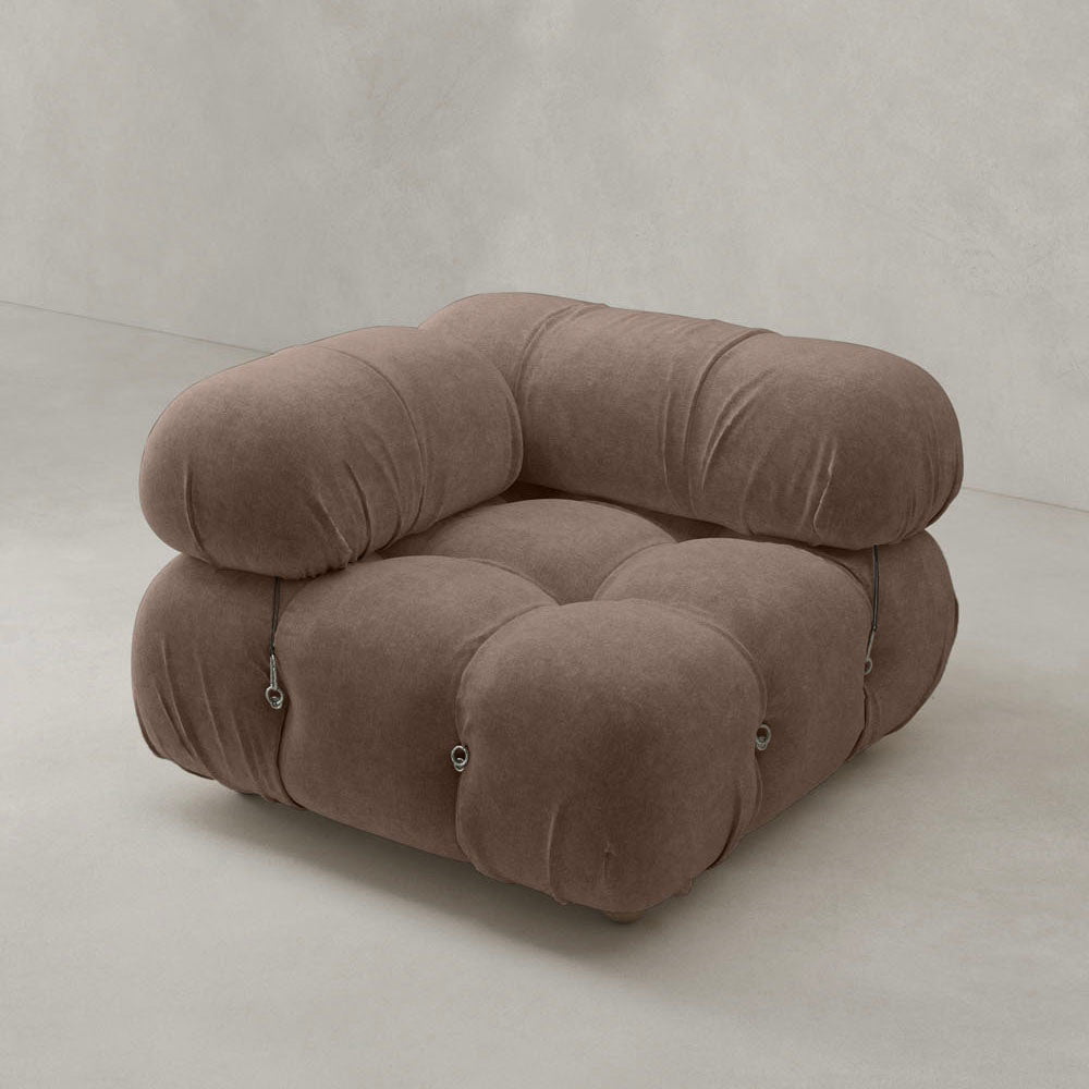 The Belmont Sofa Right Armrest features a plush, tufted design in soft brown fabric and rounded arms, creating an iconic classic look against a light, minimalist background.