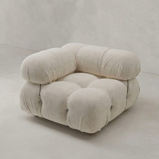 The Belmont Sofa Right Armrest features a plush, tufted design in soft beige fabric with rounded, overstuffed cushions and metal side fasteners—its modular build lets you create your ideal layout, shown on a light, plain background.