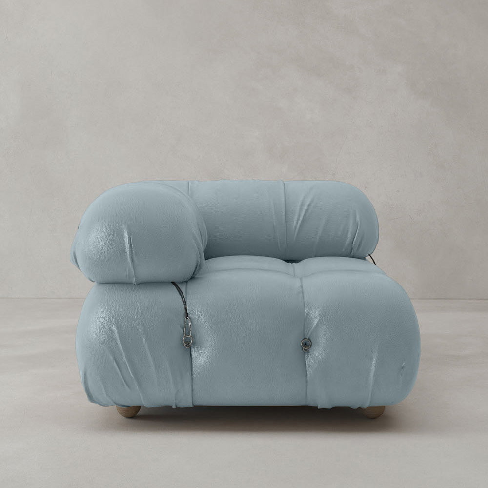 The Belmont Sofa Right Armrest, upholstered in light blue fabric with rounded edges and visible seam details, adds iconic classic appeal to any space, shown against a plain light gray background.