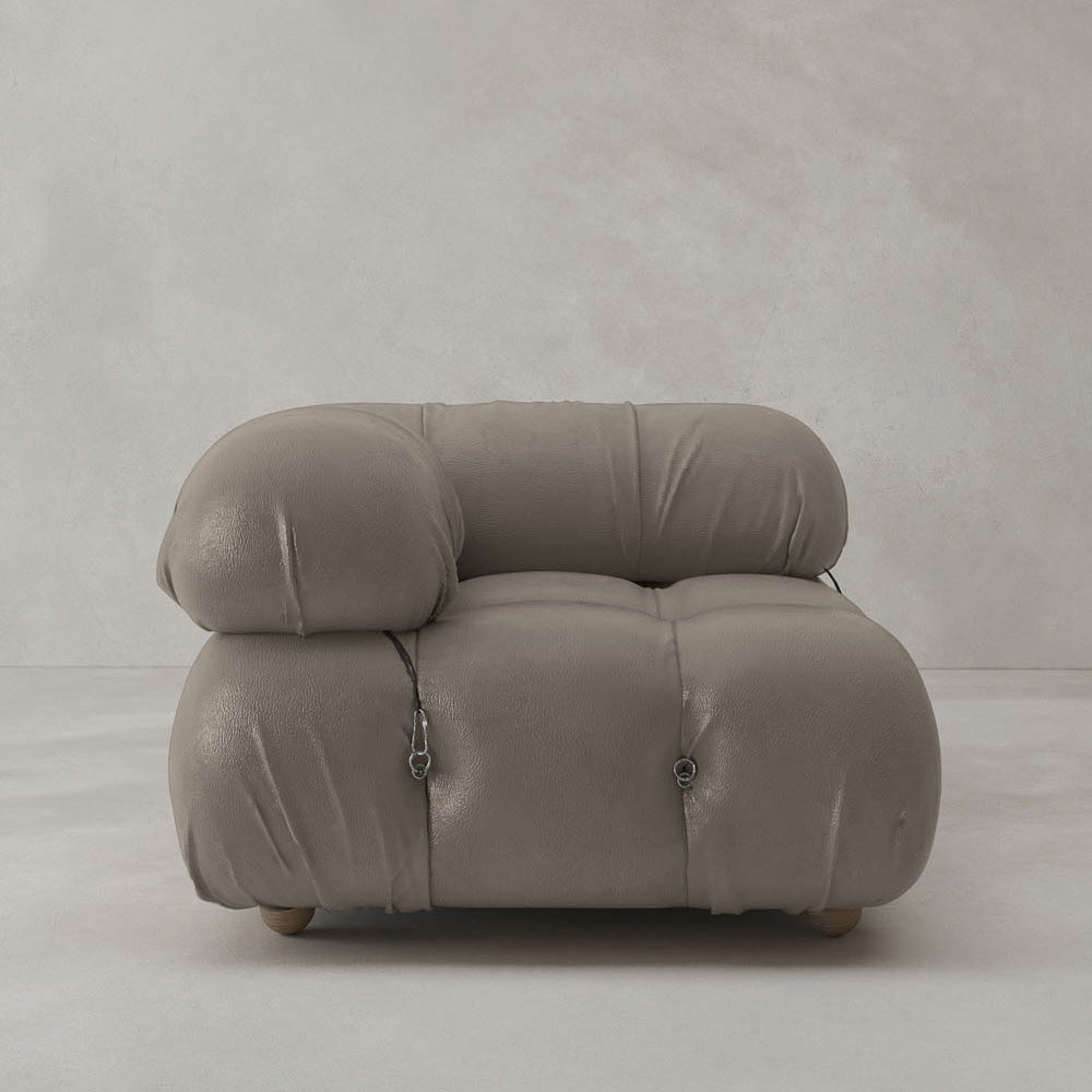 The Belmont Sofa Right Armrest features a modern, taupe design with plush cushioning, visible buckles and stitching, and an iconic classic style. Presented against a plain light gray background.