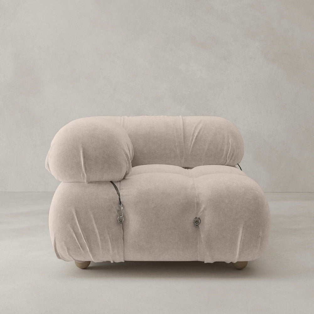The Belmont Sofa Right Armrest features a plush, light beige design with rounded, overstuffed cushions and visible metal fasteners, highlighting modular style against a plain light gray background.