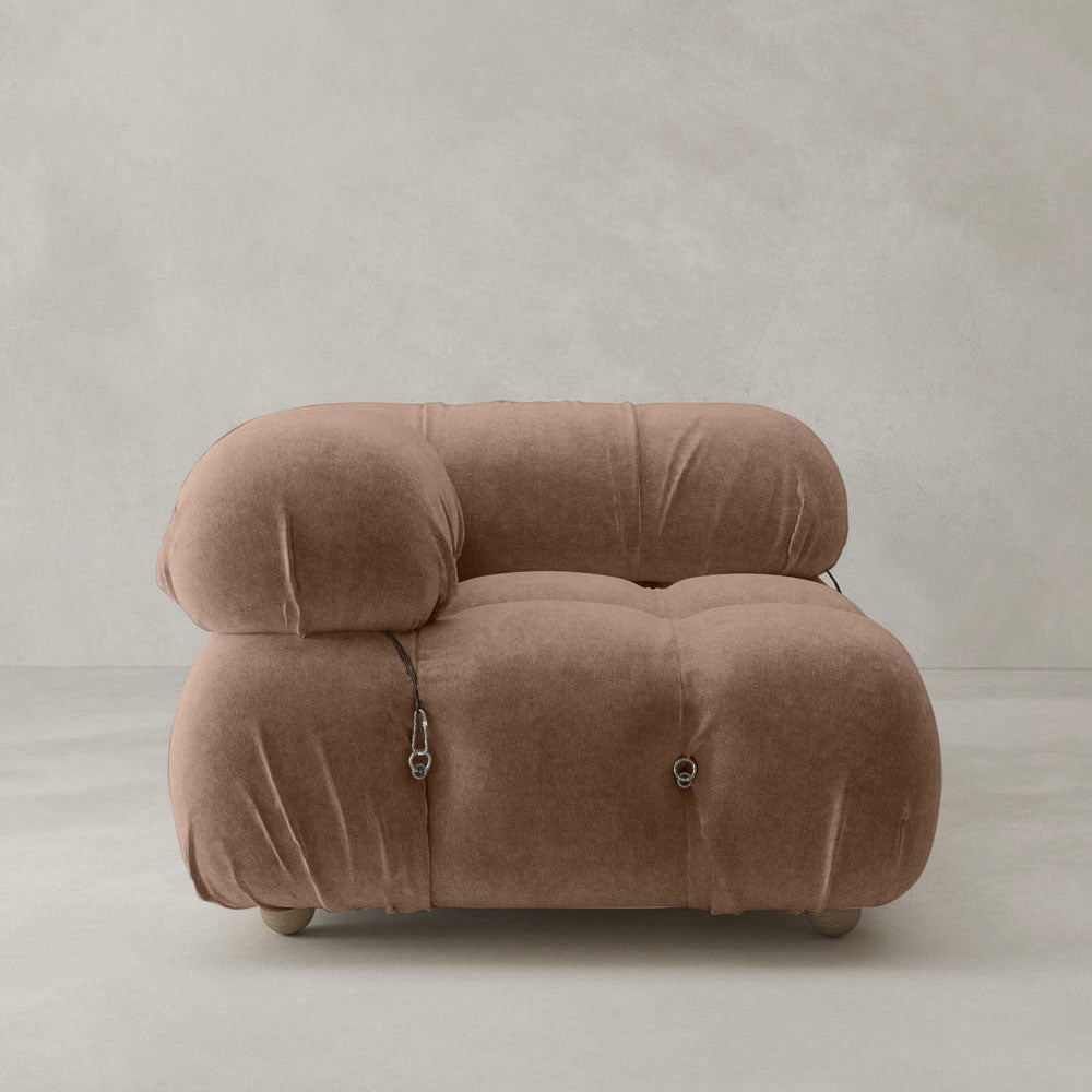 The Belmont Sofa Right Armrest features a plush, modern brown design with rounded cushions and visible metal fasteners, highlighting its modular style against a plain light gray background.