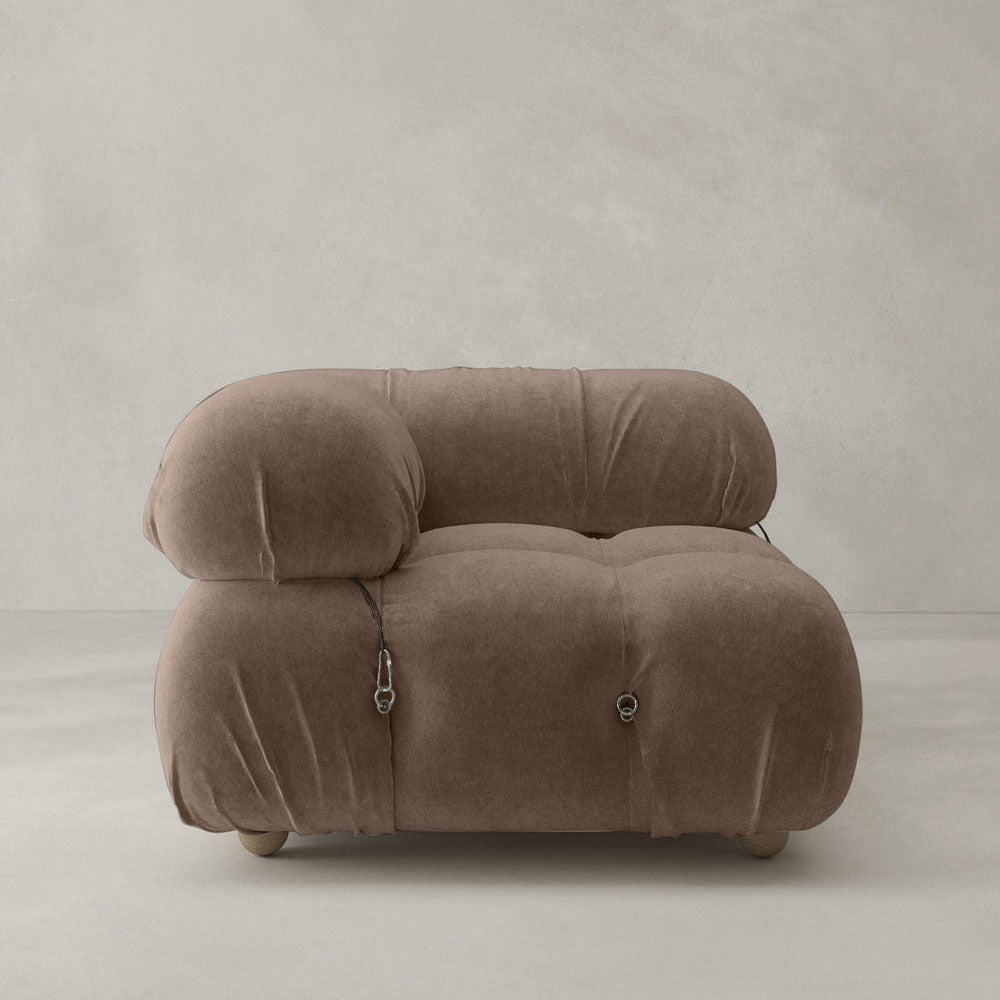 The Belmont Sofa Right Armrest features a modern, plush brown design with rounded tufted details and visible metal fasteners, adding iconic classic appeal to any space against a light-colored background.