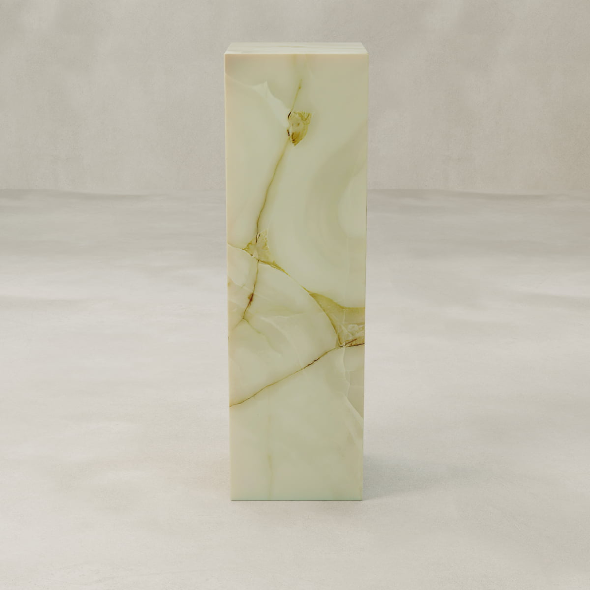 The Blanchaire Onyx Tall Tower Plinth is a tall, rectangular pedestal crafted from light beige marble with brown and gold veining, featuring a luminous finish that makes it a striking accent atop a smooth, light gray surface against a neutral background.
