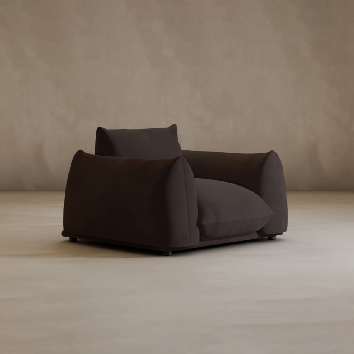 Experience modern elegance with the Calypso Arm Chair—an oversized chair with deep, plush cushions and wide armrests, upholstered in dark brown fabric, set against a simple neutral background.