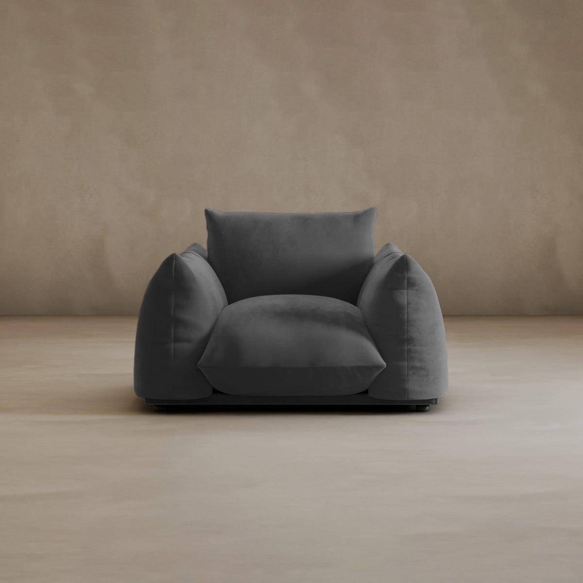 The Calypso Arm Chair offers plush comfort with dark gray upholstery, wide armrests, and a deep seat, bringing modern elegance to any room.