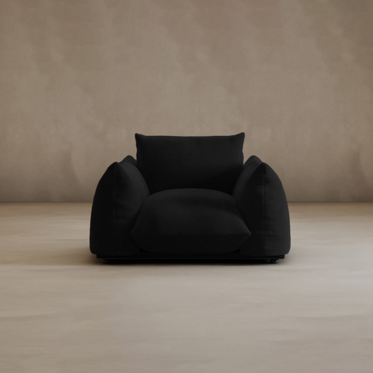 The Calypso Arm Chair features plush comfort and overstuffed cushions, set on a smooth beige floor against a plain beige wall, radiating modern elegance.