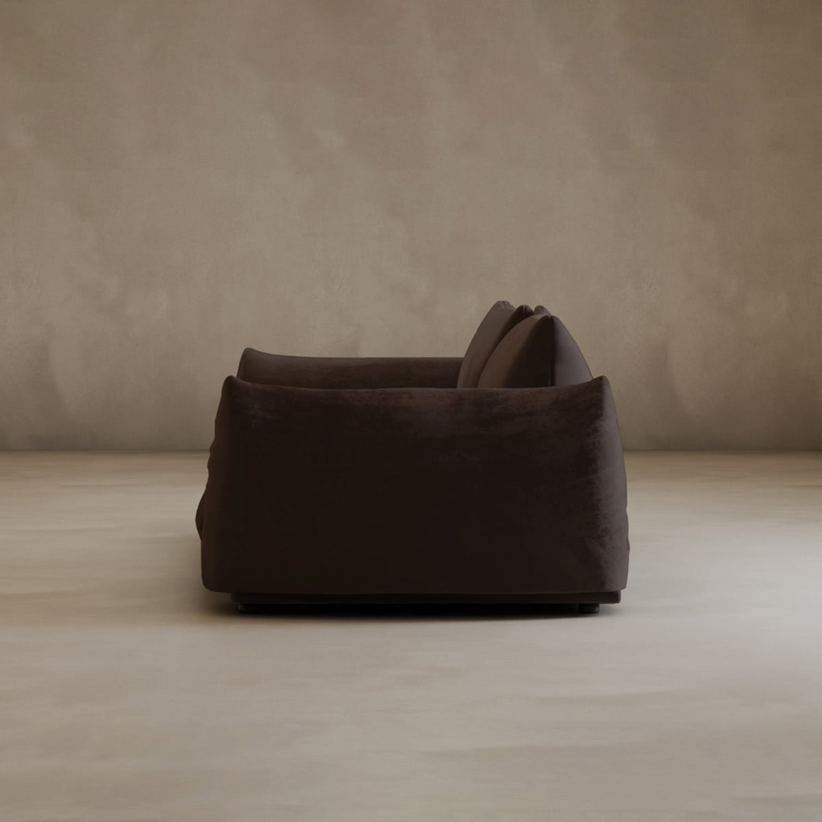 The Calypso Loveseat features modern elegance with dark brown plush upholstery and two cushions, shown from the side against a plain beige wall and floor.