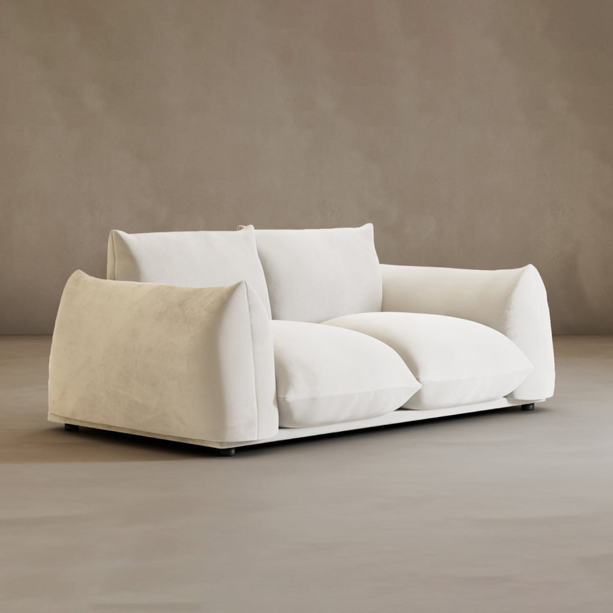 The Calypso Loveseat features plush, overstuffed white cushions and slightly slouched arms, exuding modern elegance against a neutral-toned background.