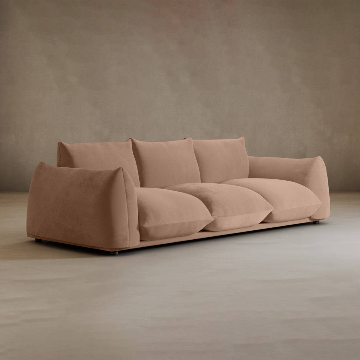 The Calypso Three Seater Sofa features a modern, minimalist design with soft, oversized cushions in light brown fabric—ideal for enhancing your living room’s style against any neutral backdrop.