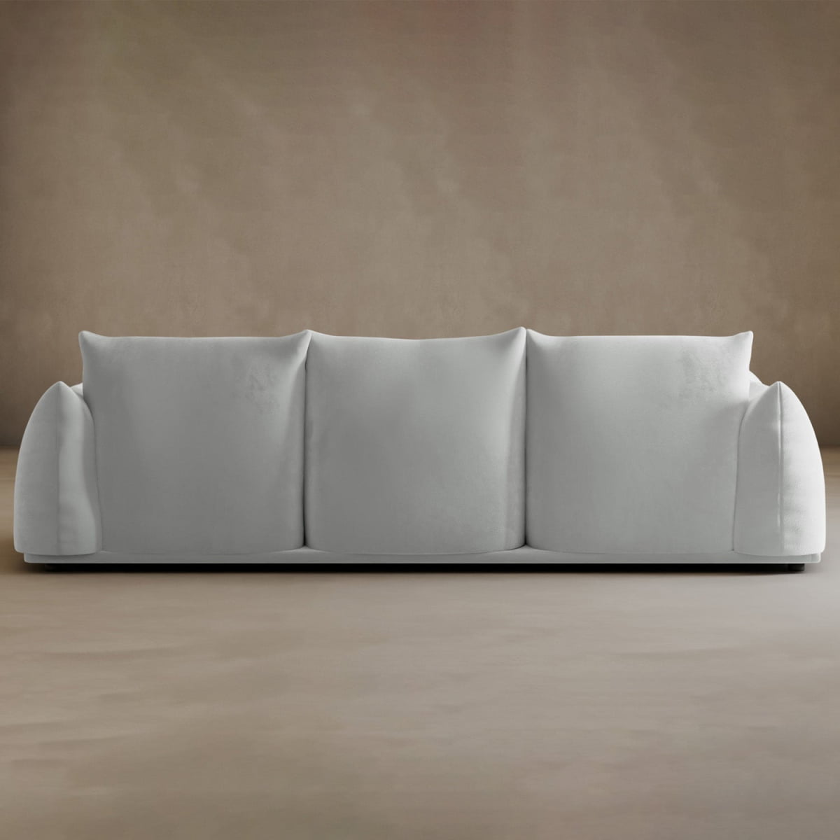 The Calypso Three Seater Sofa, featuring three roomy cushions and plush armrests, stands out against a simple beige wall—an elegant, modern addition to your living room furniture.