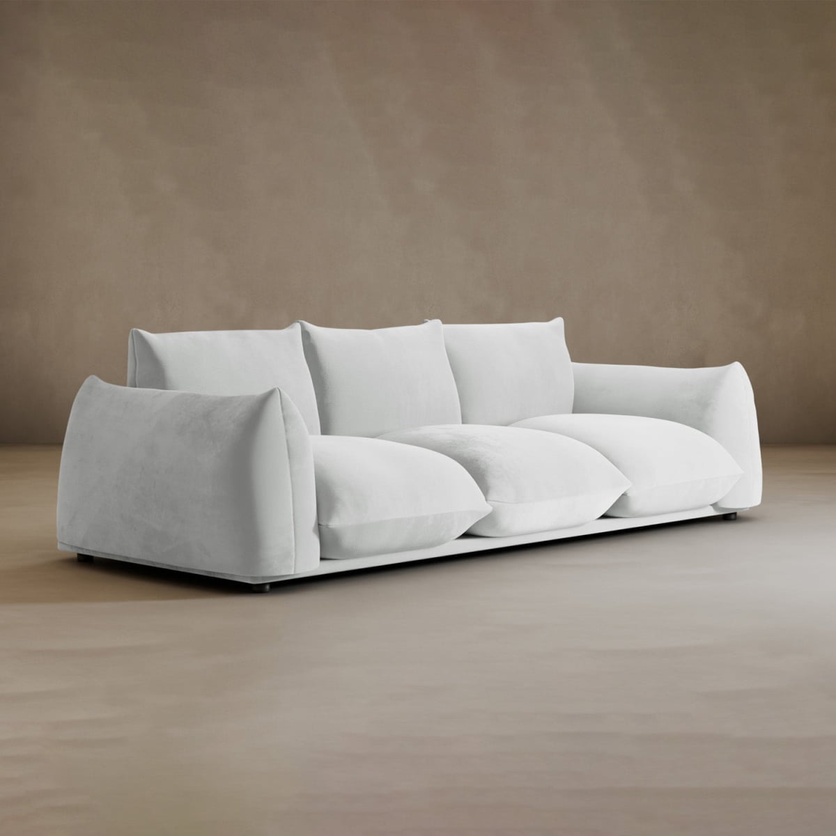The Calypso Three Seater Sofa, featuring deep cushions and sloped, overstuffed armrests, sits on a neutral light brown floor against a plain beige wall—an ideal choice for stylish living room furniture.