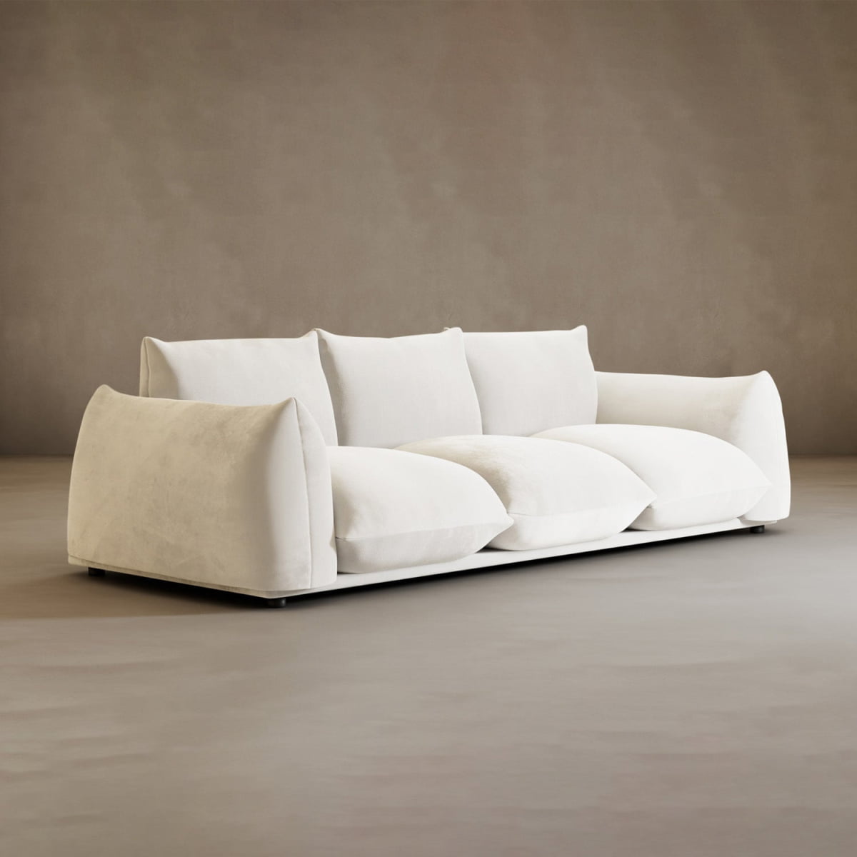 The Calypso Three Seater Sofa features deep, plush cushions and wide armrests, set on a light gray floor against a taupe wall—making it a welcoming modern centerpiece for any living room.