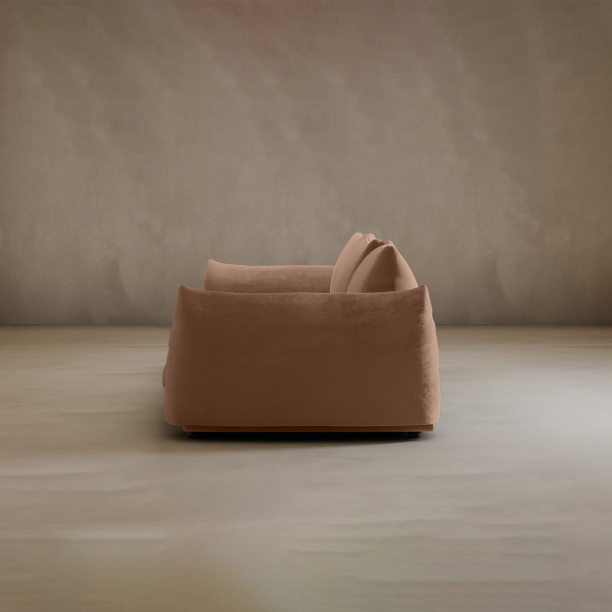 The Calypso Three Seater Sofa, with its soft tan upholstery and minimalist design, stands against a neutral wall—making it an ideal modern centerpiece for your living room.