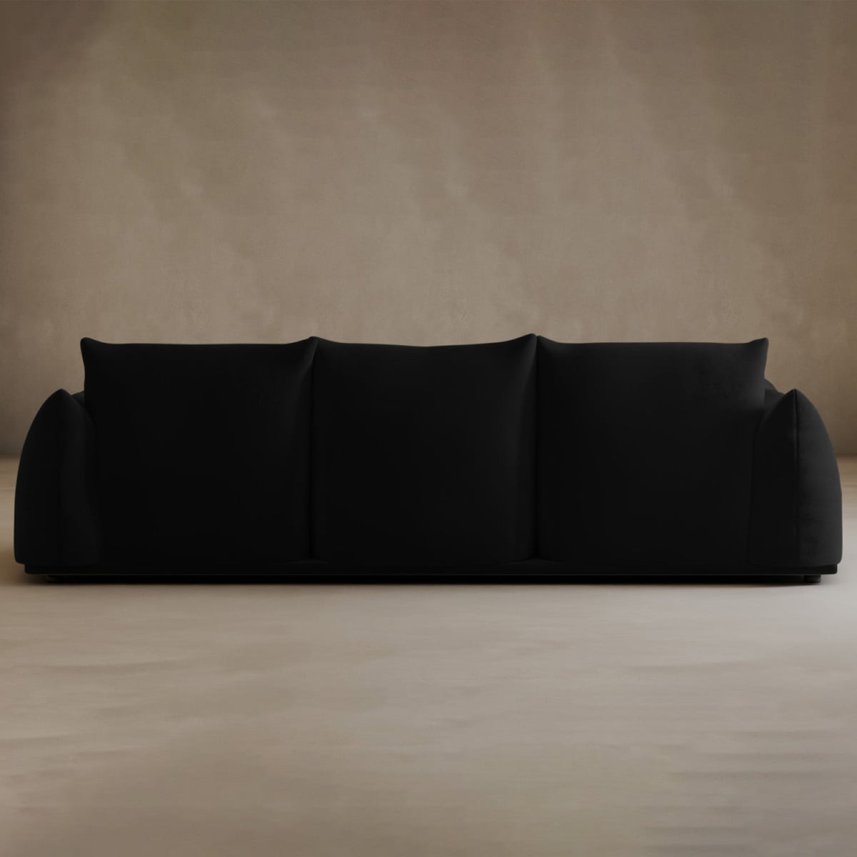 The Calypso Three Seater Sofa features three seat cushions and soft, rounded armrests—a modern choice to upgrade your living room, shown here against a beige wall on a light floor.