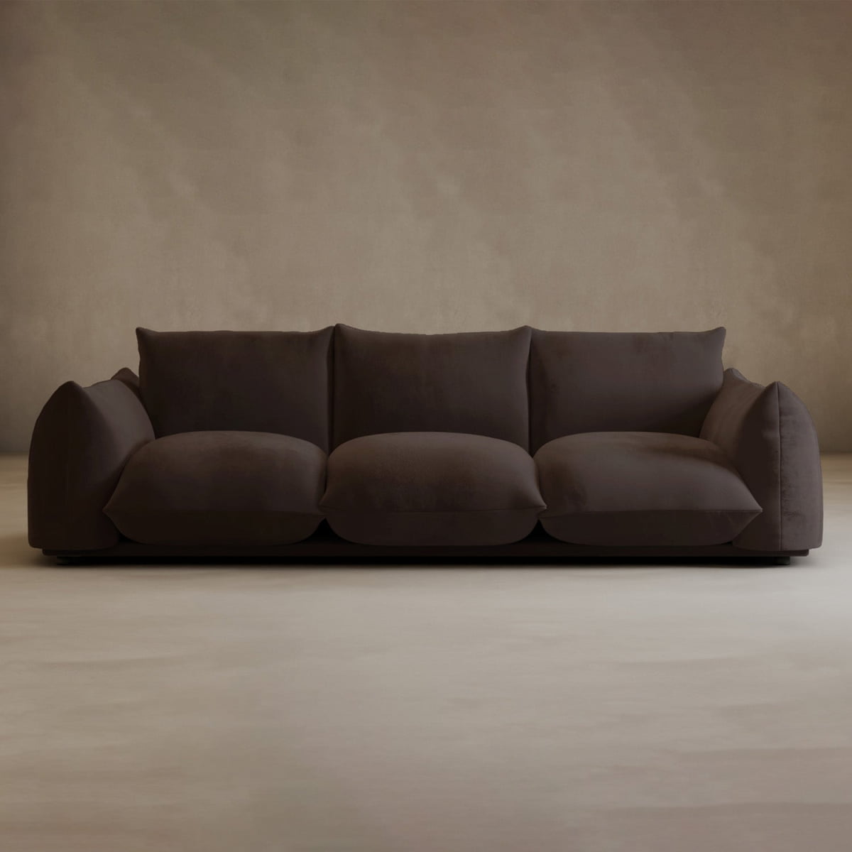 The Calypso Three Seater Sofa, in plush dark brown with three large seat cushions and overstuffed armrests, is a modern addition that enhances your living room décor against a beige wall and light floor.