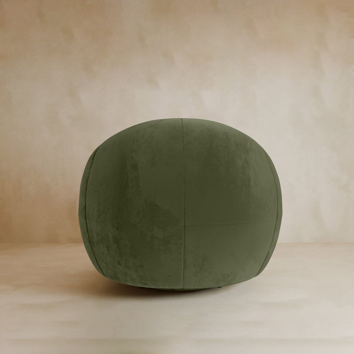 The Clara Armchair, with plush velvet upholstery in olive green, brings a touch of contemporary style as it sits on a beige floor against a soft beige background.