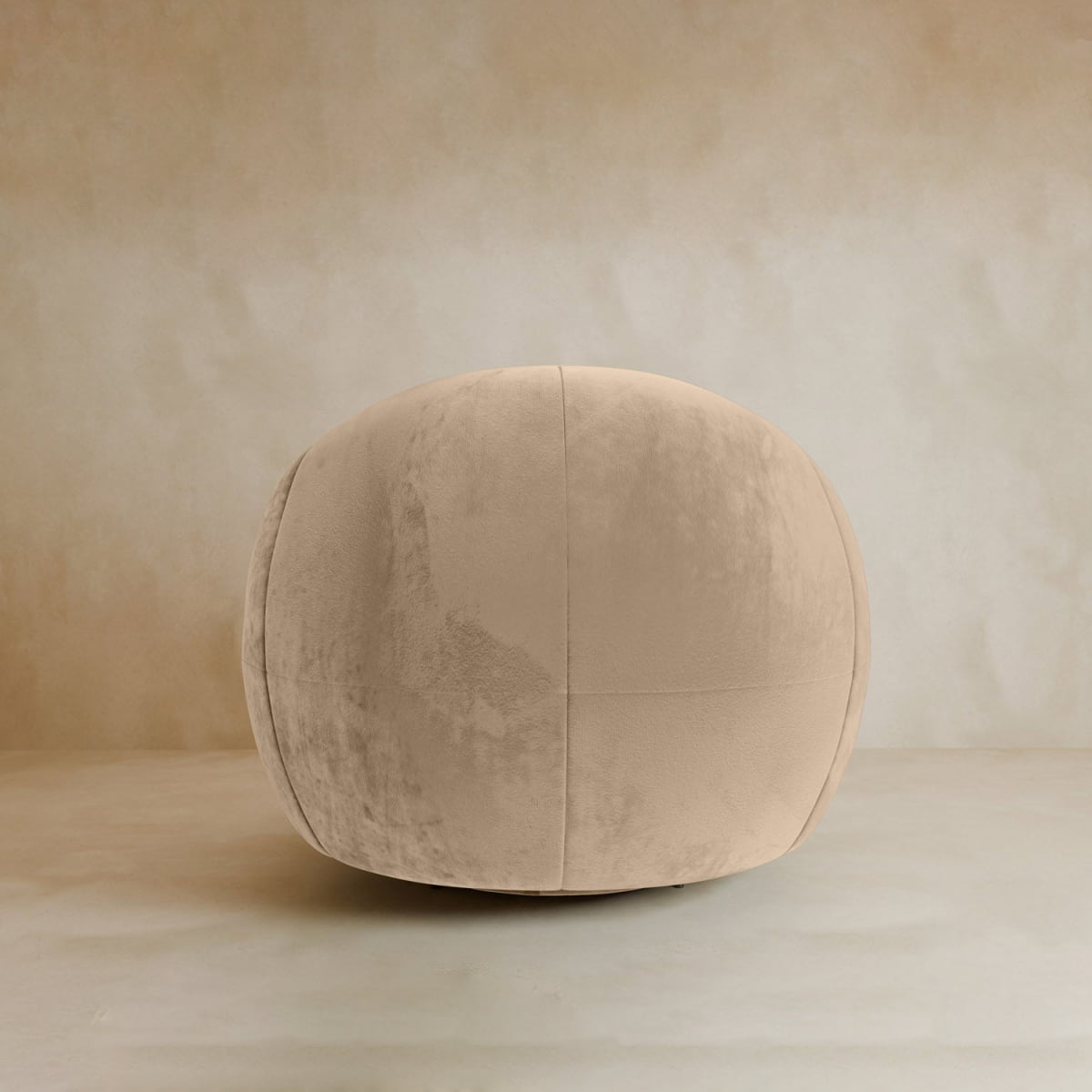 The Clara Armchair, with its sleek velvet upholstery, stands out in a neutral-toned room with a plain, light background, bringing a touch of contemporary style.