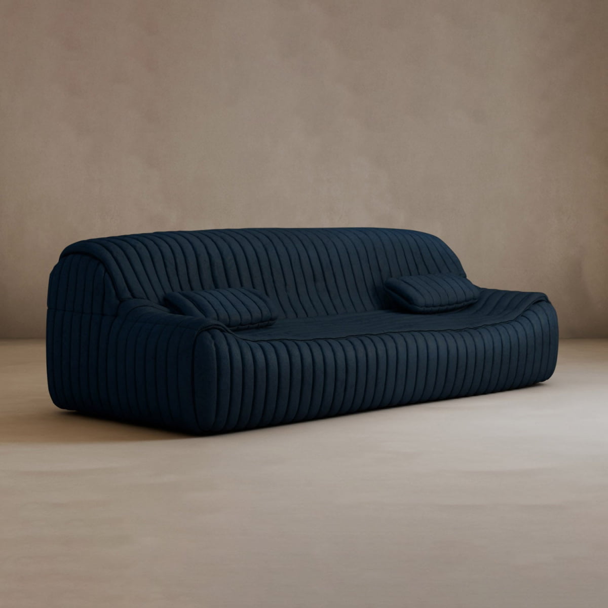 The Calypso Armchair exudes modern elegance with its dark blue hue, tufted stripe design, and two matching cushions, all set against a plain beige background.