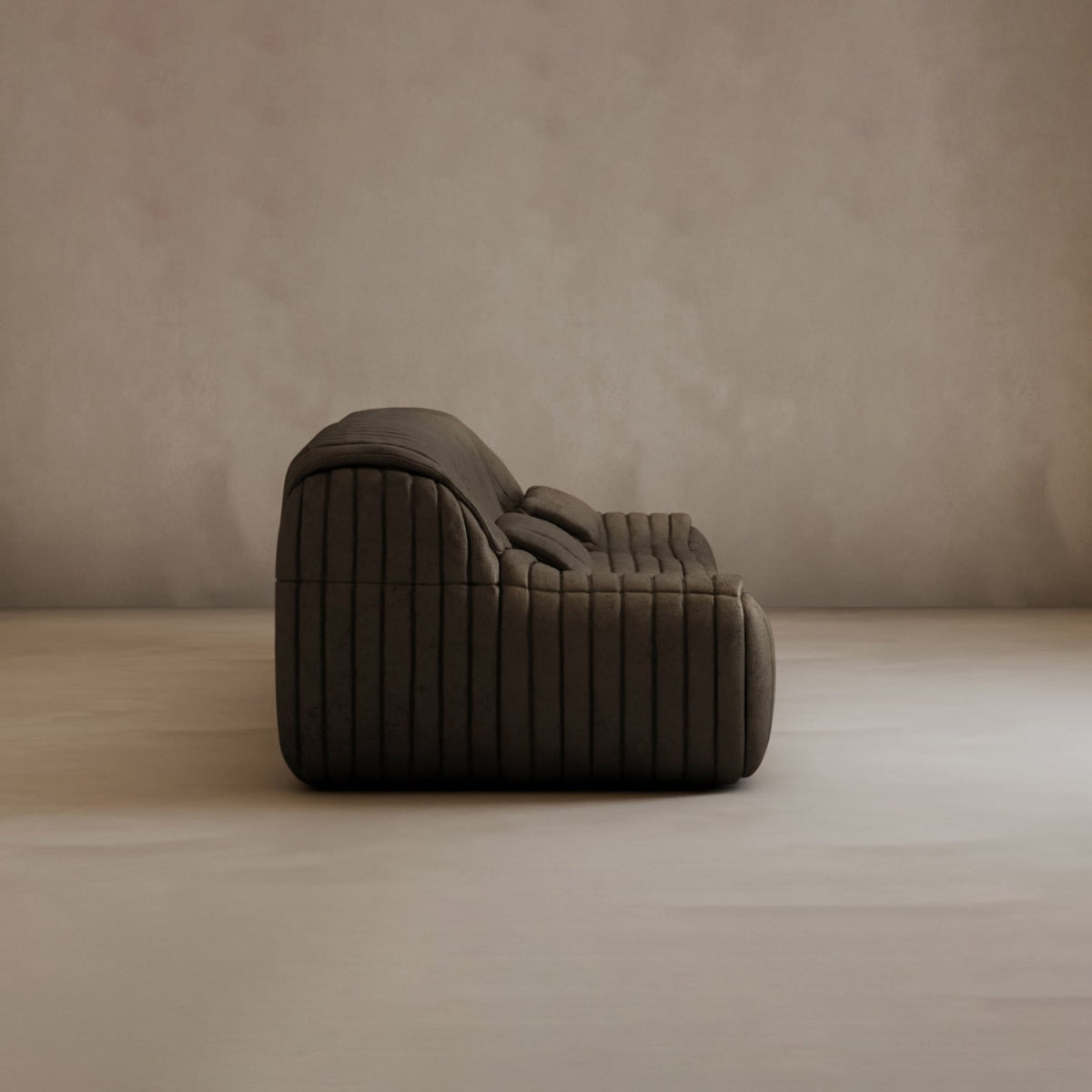 Modern elegance defines the Calypso Armchair, featuring dark brown corduroy upholstery with a tufted stripe design, low profile, and plush cushions set against a plain light beige wall in a minimalist setting.