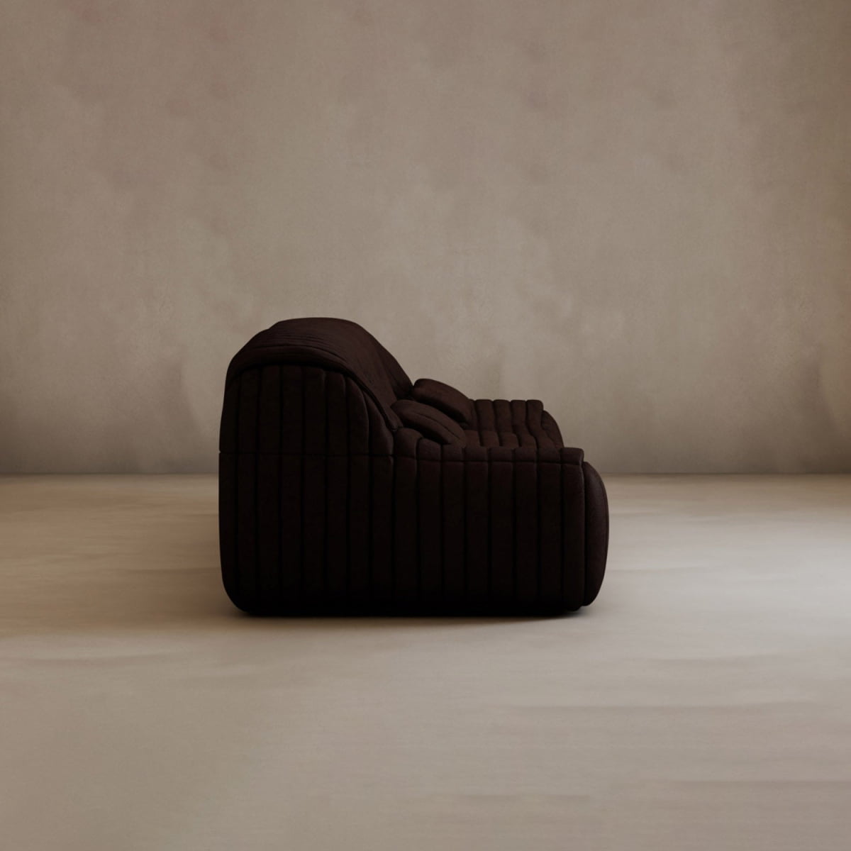 The Calypso Armchair, a dark brown modern lounge chair with a tufted stripe design and quilted cushioning, sits in the center of a softly lit, minimal room with light beige walls and flooring, radiating modern elegance.