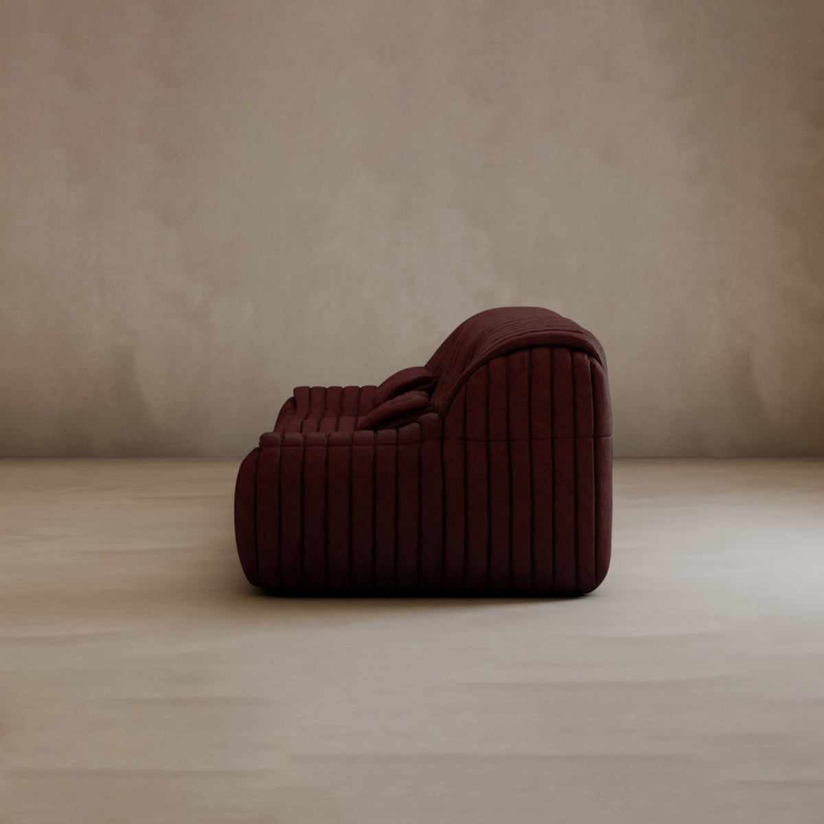 The Calypso Armchair is a deep burgundy lounge chair with a tufted stripe design, shown in profile against a light beige background, radiating modern elegance.