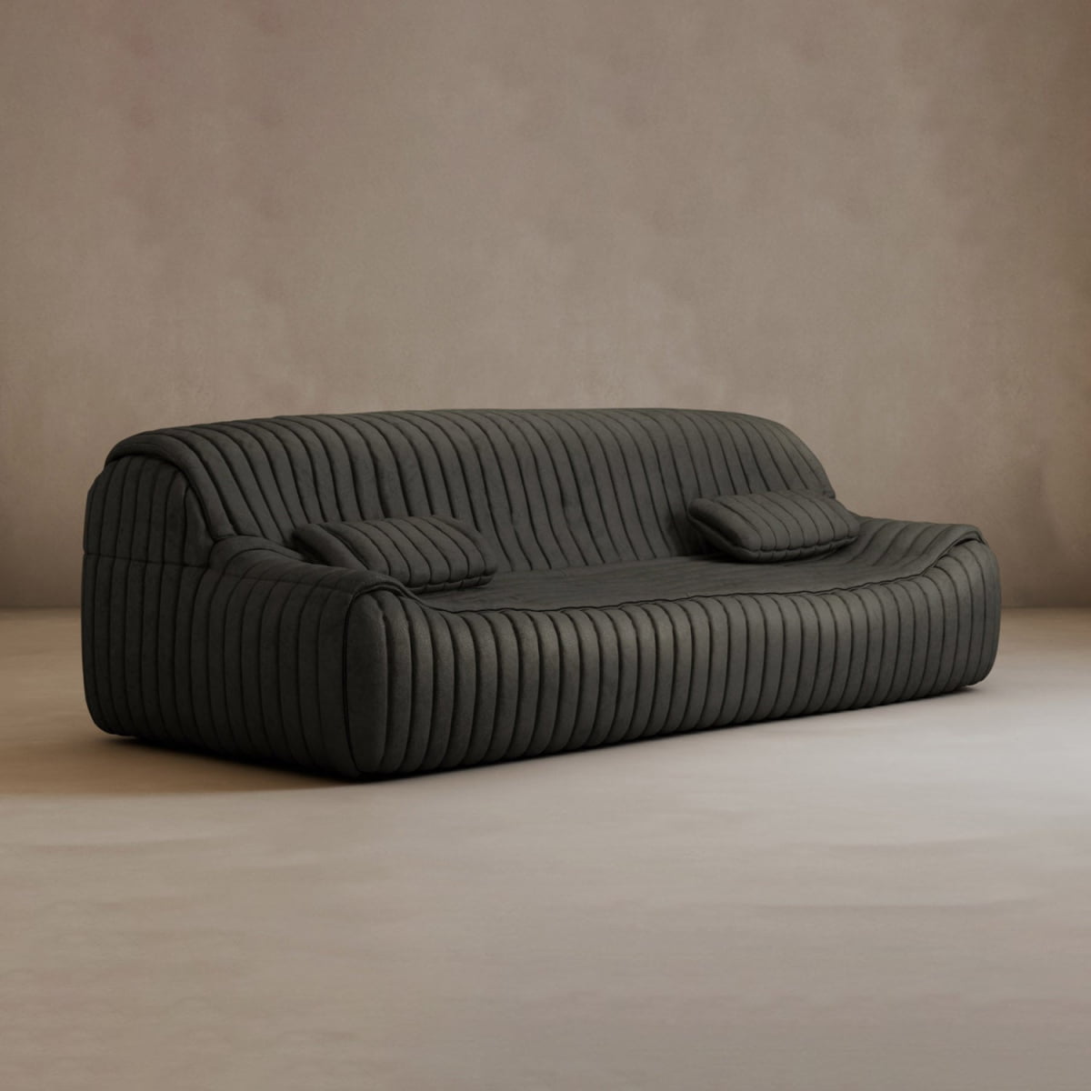 The Calypso Armchair exudes modern elegance with its dark gray color, vertical tufted stripe design, rounded edges, and matching rectangular cushion, set against a plain beige wall and light floor.