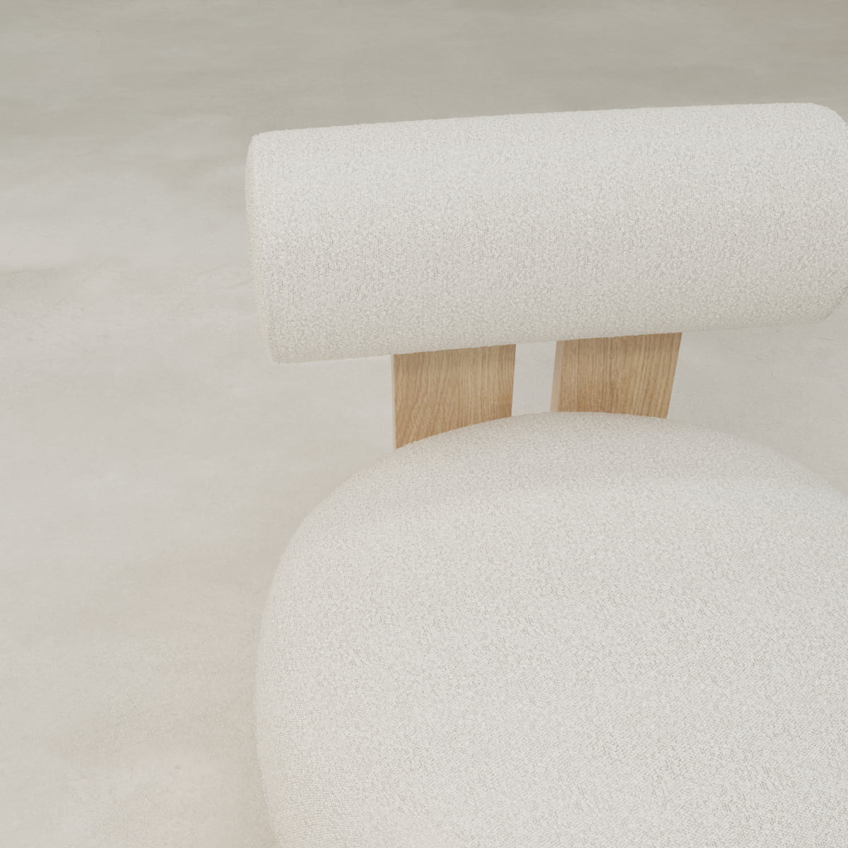 Minimalist image of the Finchley Chair, featuring a modern design with a round textured white cushion, matching cylindrical backrest, and two solid wooden legs, set against a neutral light-colored background.