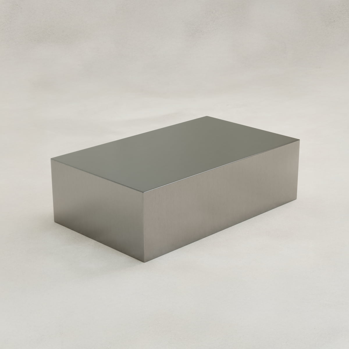 The Forge Steel Large Rectangular Plinth features a plain, shiny steel finish and smooth edges, displayed on a light, neutral background to highlight its modern design.