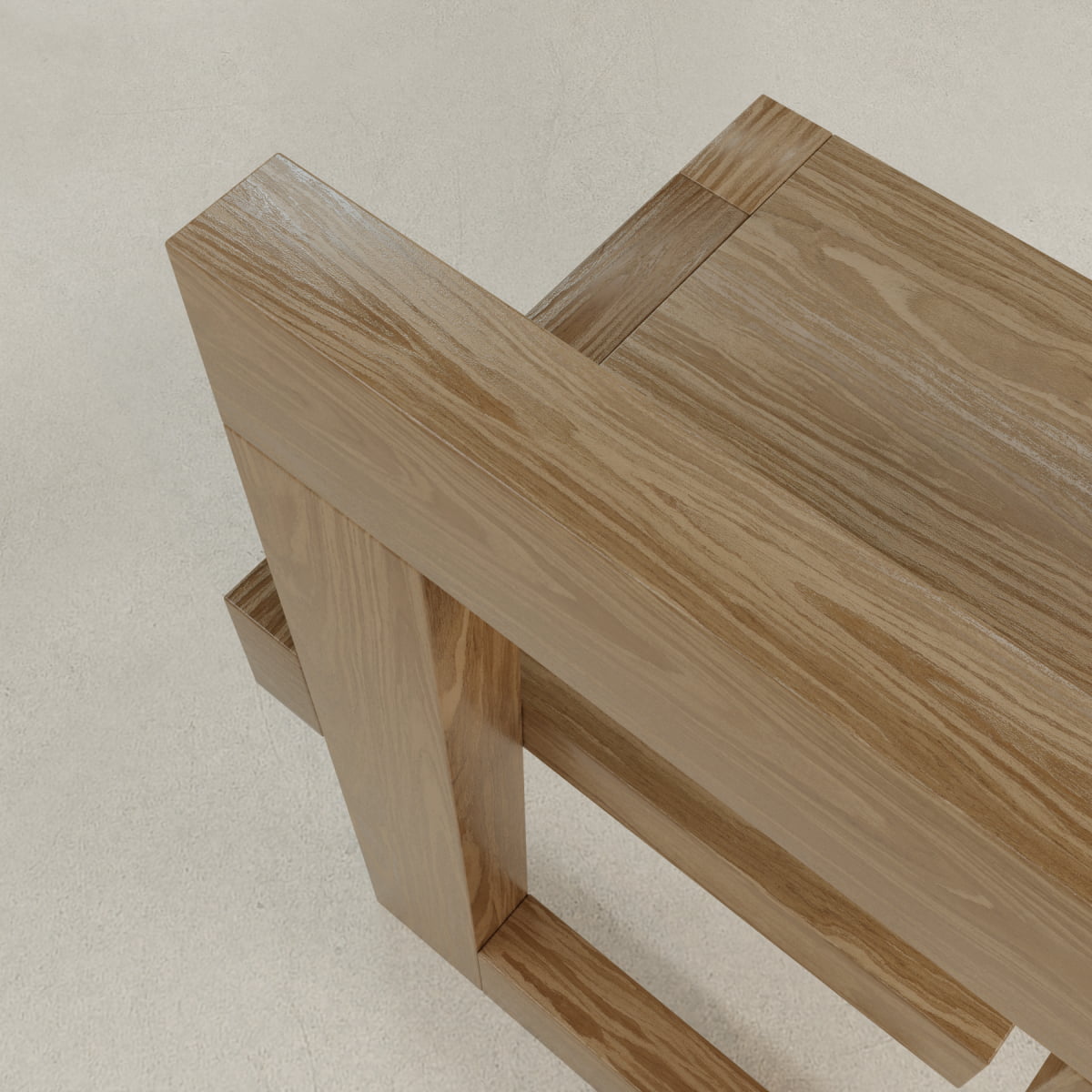 Close-up of the Grafton Chair, featuring clean angular lines and a smooth natural grain finish, echoing Brutalist elegance as it sits atop a light-colored textured floor.