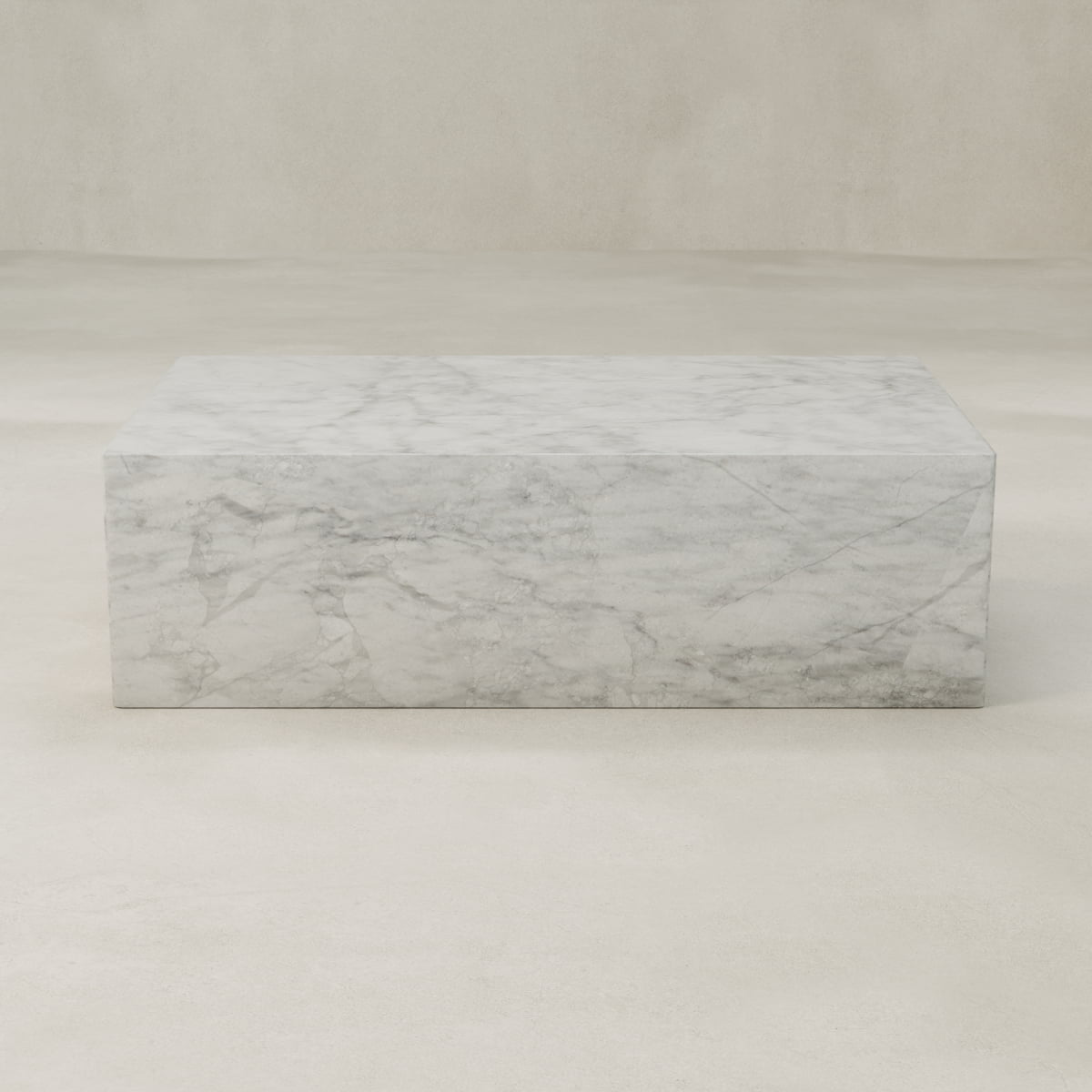 The Griselle Marble Coffee Table features a rectangular shape with grey veining and a minimalist, modern design. Its sculptural look adds elegance to any living space, beautifully complementing light, neutral backgrounds.
