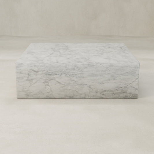 The Griselle Marble Coffee Table XL features elegant, refined white marble with graceful grey veining, all showcased against a plain, light-colored background.