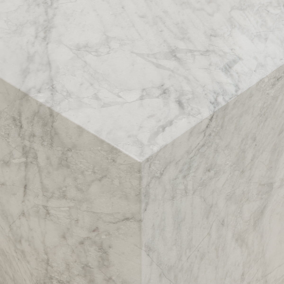 Close-up view of the Griselle Marble Plinth - Cube, crafted in creamy stone with light gray veining, smooth surfaces, and sharp edges that create a refined minimalist silhouette.