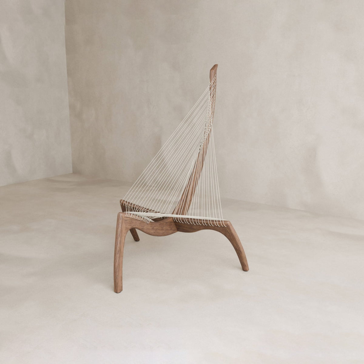 The Harp Chair is a modern ash wood chair inspired by Danish design, with a sculptural triangular form and white vertical cords from seat to high backrest, displayed in a minimal, light-hued room.