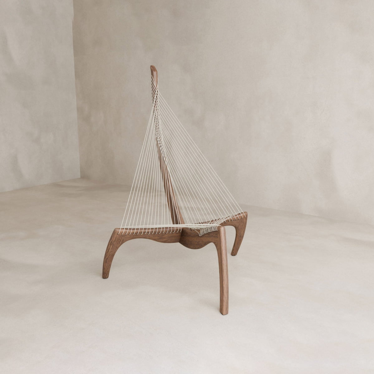 The Harp Chair is a modern ash wood chair with three legs and a triangular white cord backrest in a Mid-Century Modern design, showcased against a minimalist background.