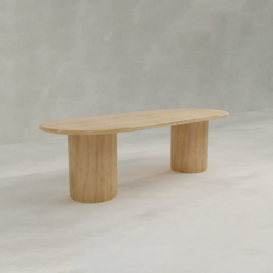 The Lancaster Oval Dining Table features an oval top and two wide cylindrical legs, crafted from high-quality wood, set against a light gray background.