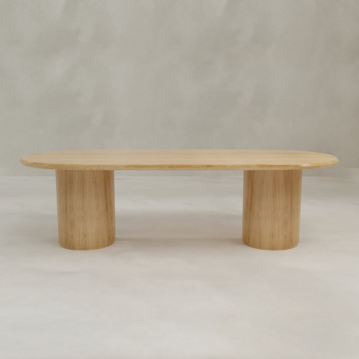 The Lancaster Oval Dining Table showcases a modern design with a smooth, high-quality wood oval top and two cylindrical ribbed bases, perfect for contemporary dining spaces.