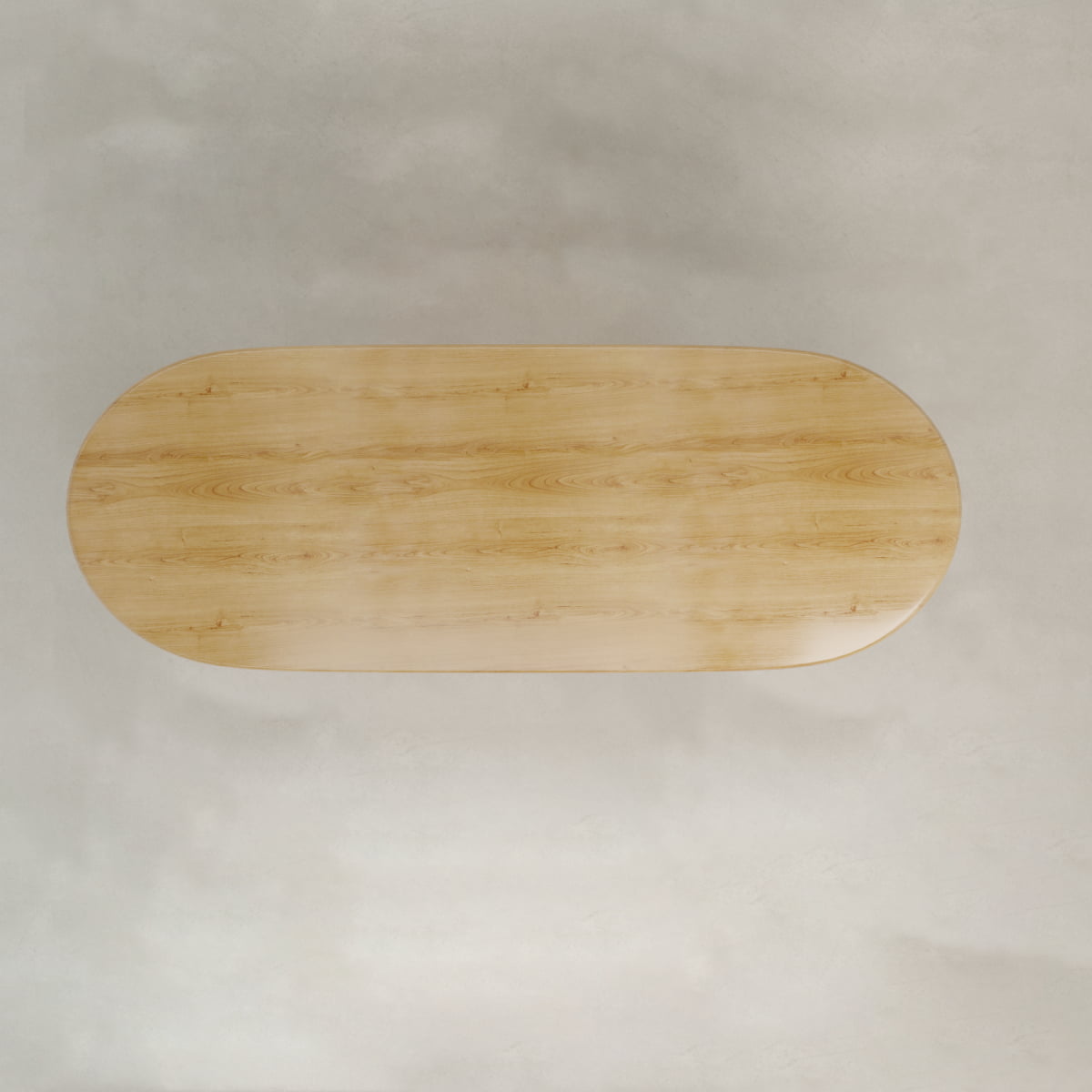 A top-down view of the Lancaster Oval Dining Table, crafted from high-quality wood with a modern design. The light wooden table is oval-shaped and sits on a light-colored textured surface, free of any objects or decorations.