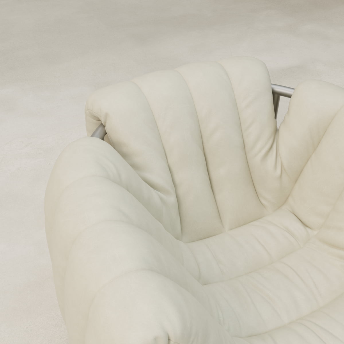 A close-up of the Mallow Chair highlights its plush cream upholstery, deep channeled tufting, and sculptural tubular frame, set against a light neutral background.