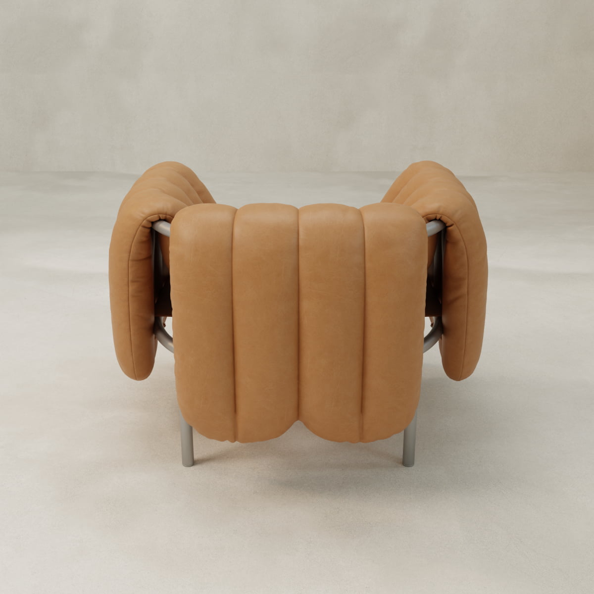 The Mallow Chair features a sculptural tubular frame and deep channeled tufting on its light brown padded leather seat and backrest, standing out against a plain, light-colored background.