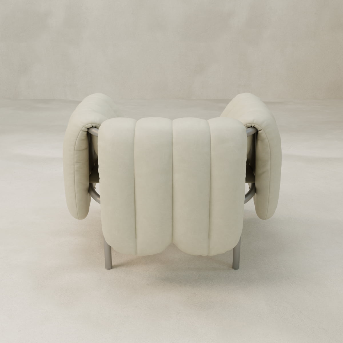 The Mallow Chair features thick cream cushions, a rounded shape, and a sculptural tubular frame, shown from the back against a light neutral background.