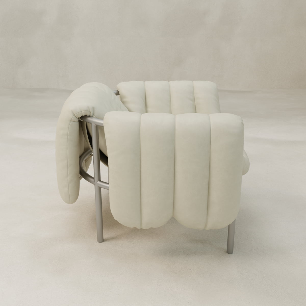 The Mallow Chair features a plush, padded cream-colored cushion and a sculptural tubular frame, set against a plain beige background.