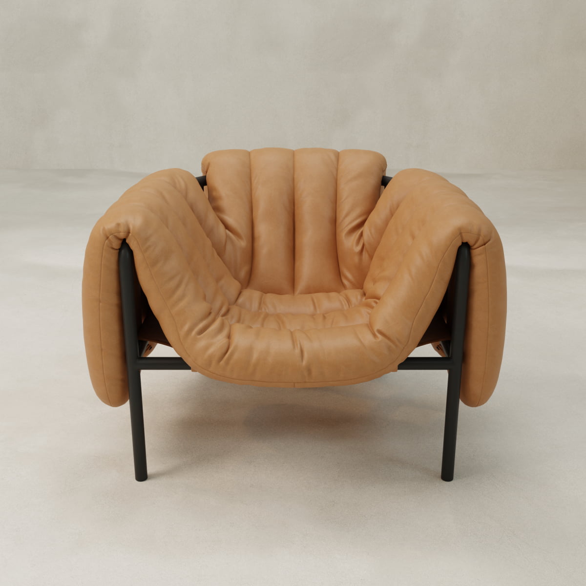 The Mallow Chair features soft tan leather upholstery, deep cushioning, and a sculptural tubular frame, set against a light neutral background for a modern look.