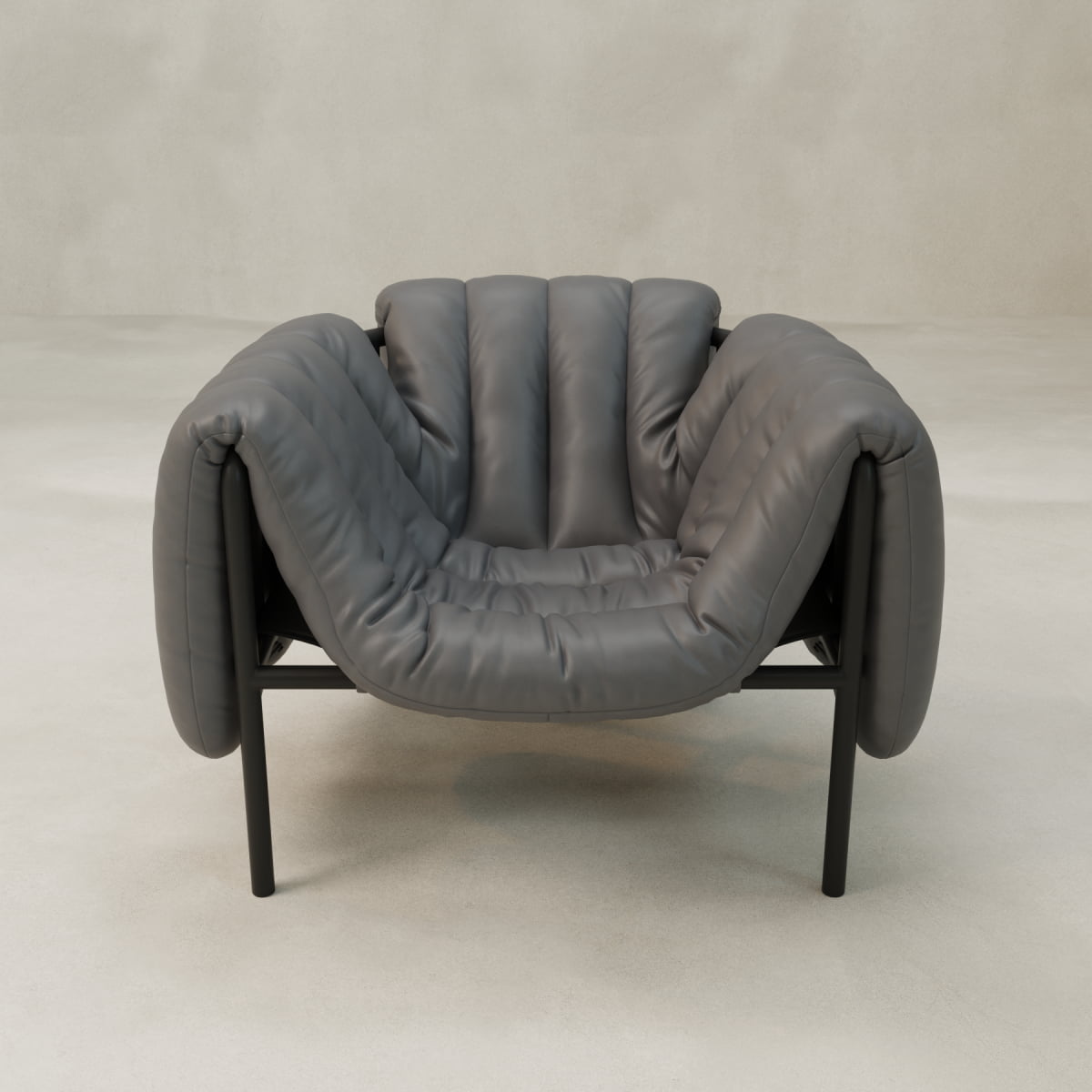 The Mallow Chair features a modern deep gray design with plush, channeled tufting, rounded edges, and black metal legs, set against a minimal light background.