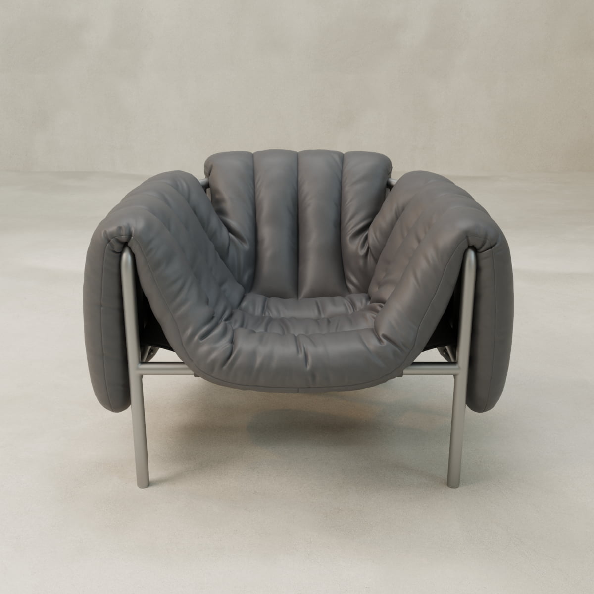 The Mallow Chair features soft, deep channeled tufting on gray leather cushions and a sculptural tubular metal frame, placed on a light floor against a beige wall.